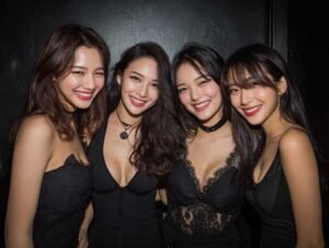 Four women smiling, wearing black dresses, ready for a night out.